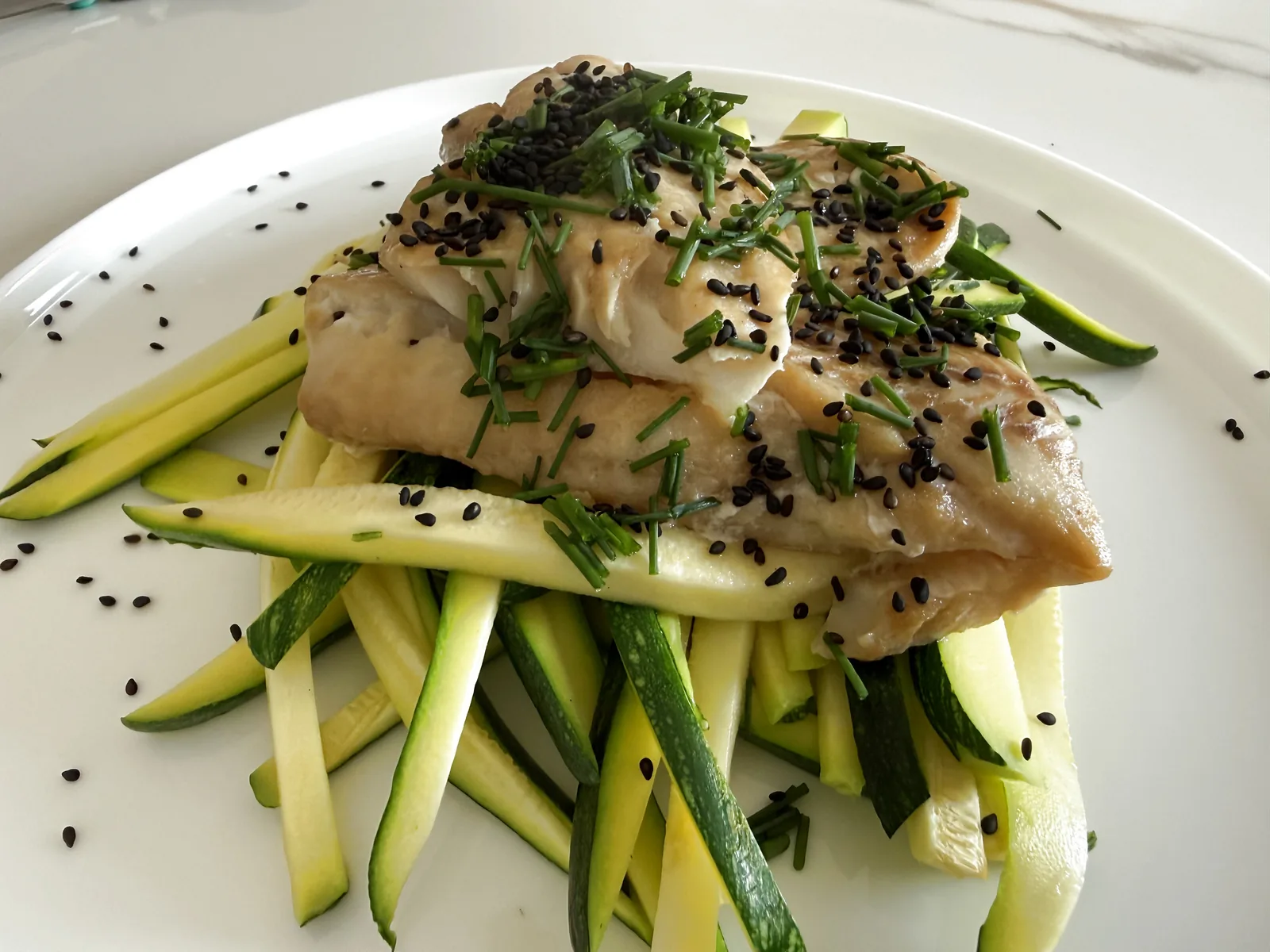 Alaska pollock with ginger and black sesame on courgette noodles